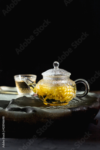 Traditional Tea Ceremony. Shen flower green tea. Glass teapot macro flower