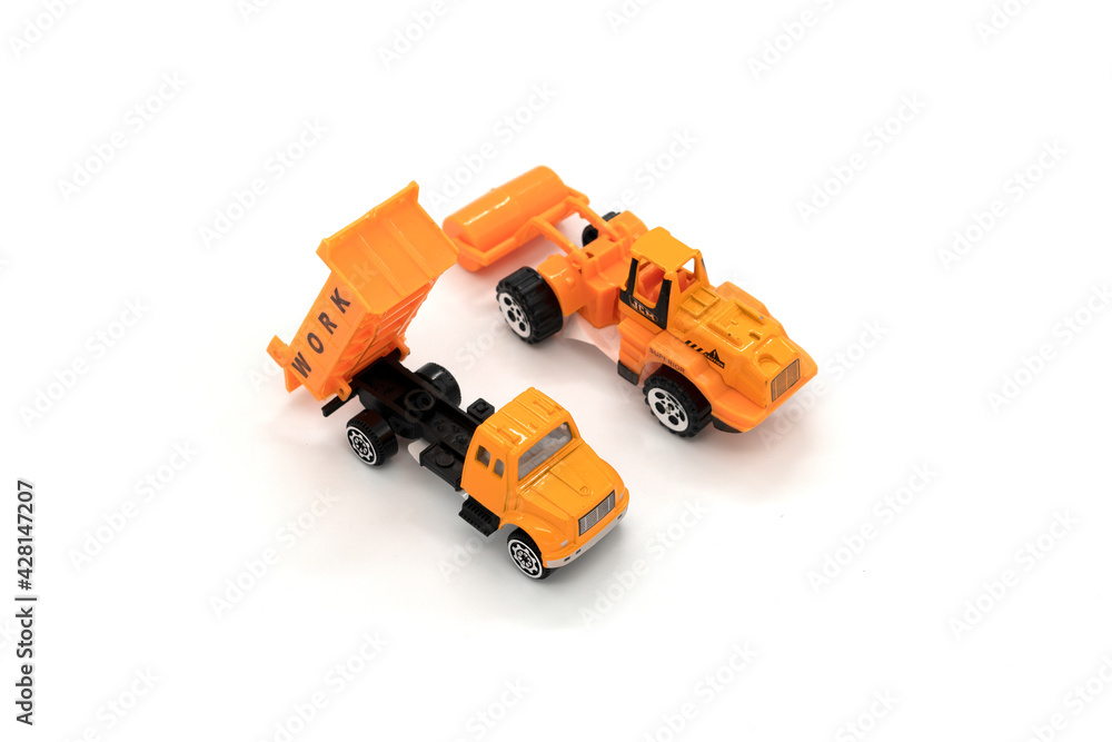 Fototapeta premium Yellow excavator and truck model toys isolated on white background.