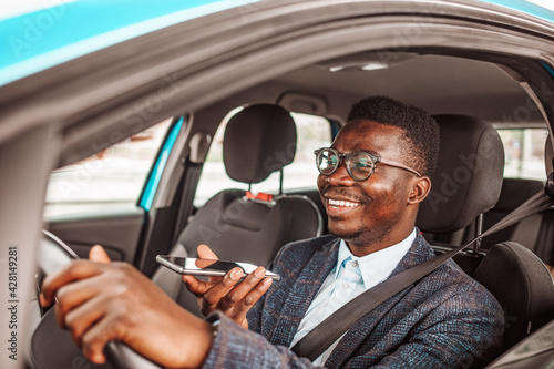 Calling by driving. Risky driver using phone while driving. Close up of a handsome young businessman talking on mobile phone in his car. Businessman Talking on the Phone while Driving a Car