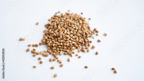 Biologically grown organic buckwheat on a white background. A bunch of buckwheat close up. Isolated