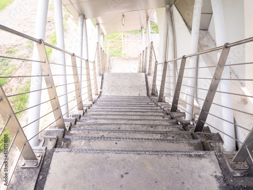 the building staircase for descending from footbridge. © tlovely