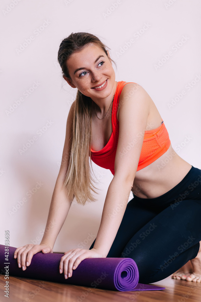 Fototapeta premium Young attractive woman with yoga mat indoors, preparing for exer