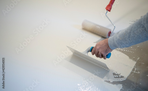 worker works with polyurethane resin for interiors
 photo