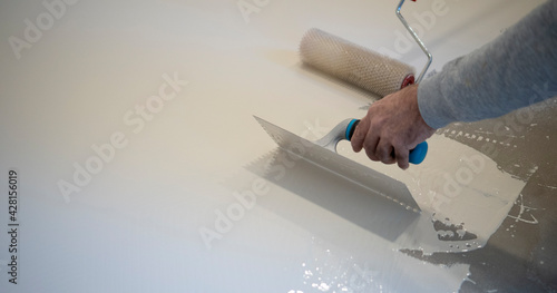 worker works with polyurethane resin for interiors
 photo