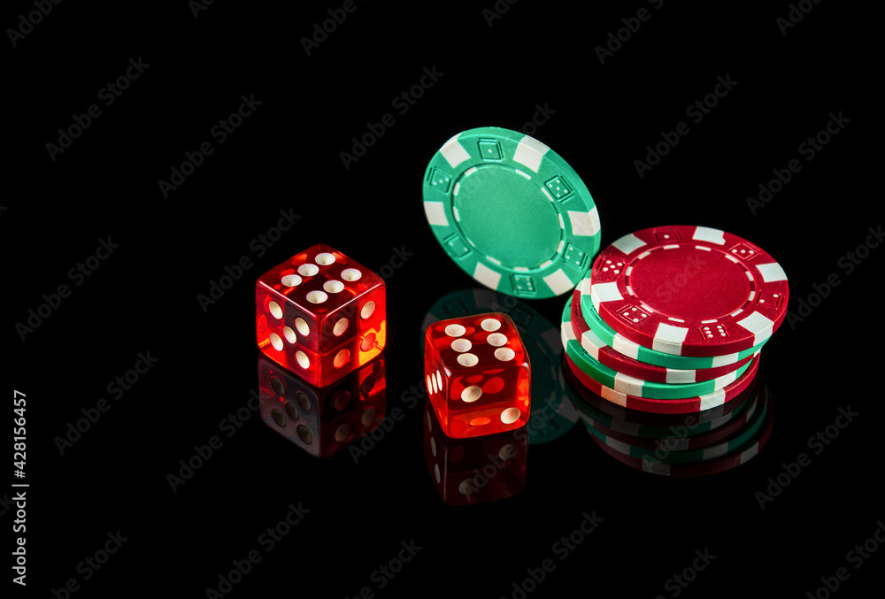 Poker dice on black background and chips. Craps club game concept Poker dice on black background and chips. Craps club game concept