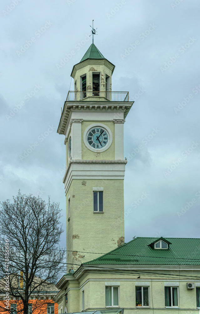 Poltava, Ukraine - April 14, 2021:Tall ancient tower with a signal bell, a traditional building of the fire department in the center of the old city of Poltava, Ukraine. Crossroads and transport 