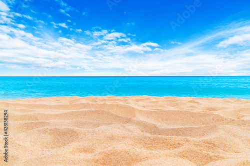Summer Vacation and Travel Holiday Concept : Sand beach and blurred seascape view blue sky in background.
