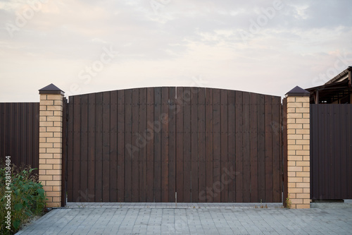 Beautiful Minimalistic brown wooden gate and fence.