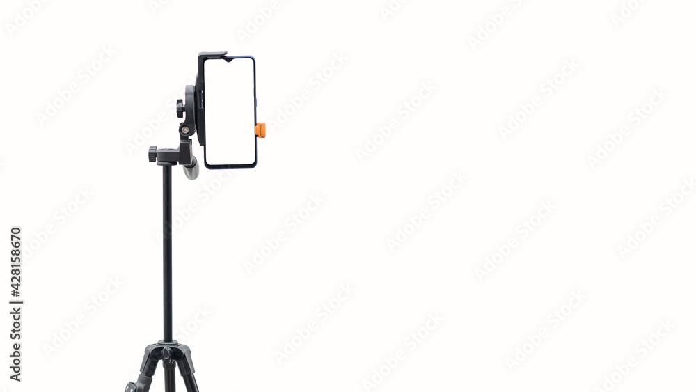 The mobile phone is put on the stand and separately on white background The mobile phone is put on the stand and separately on white background