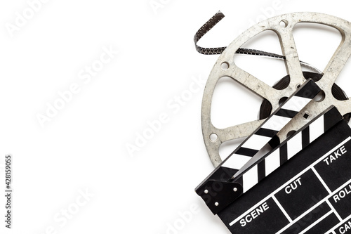 Cinema background with movie clapperboard and film reel Fototapeta