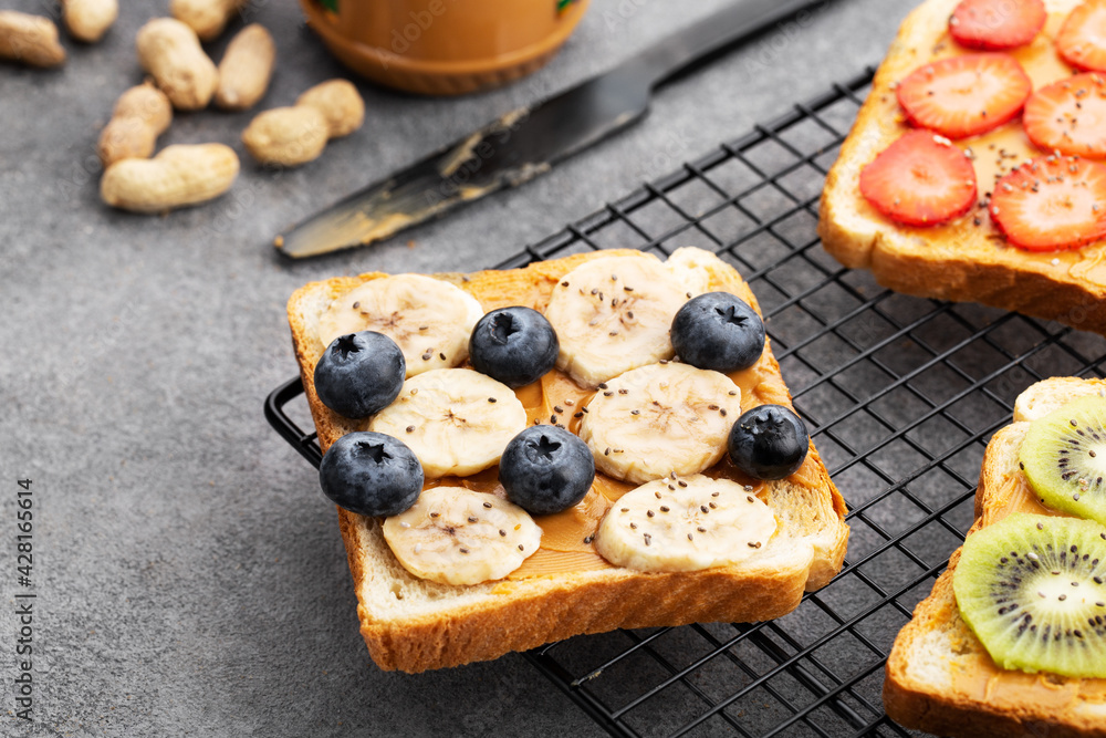 sweet toast with peanut butter, fruit and berries, close-up, banana and blueberry toast sweet toast with peanut butter, fruit and berries, close-up, banana and blueberry toast