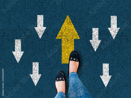 Fotografie woman shoes on asphalt and opposing direction arrows on asphalt ground, personal