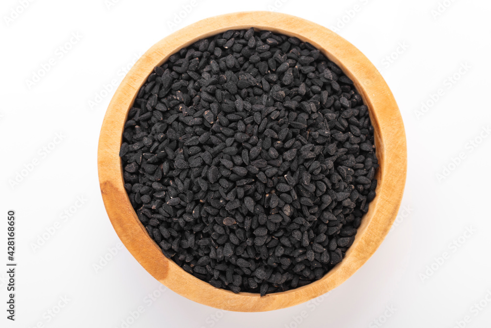 Black cumin seeds. Black cumin in wooden bowl on white background. nigella sativa, black sesame, black cumin, Black cumin seeds. Black cumin in wooden bowl on white background. nigella sativa, black sesame, black cumin,