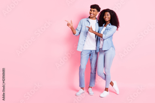 Full length body size view of nice cheerful trendy friends friendship hugging showing advert isolated on pink pastel color background