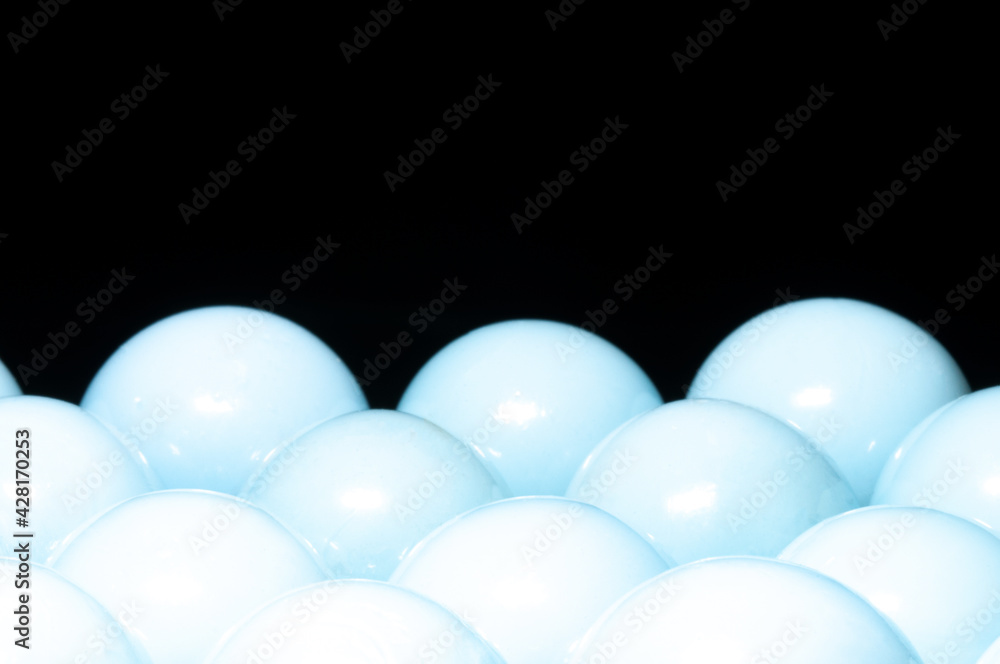 White shiny spheres in black background White shiny spheres in black background