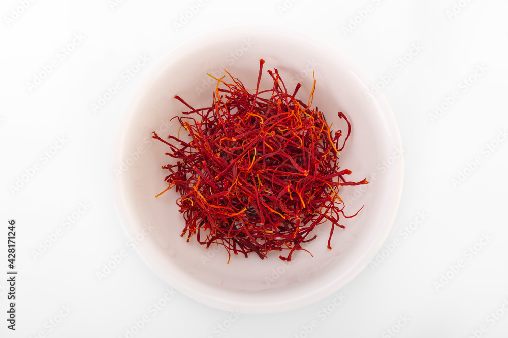 Fototapeta premium saffron. dried saffron in white bowl on white background. saffron spice