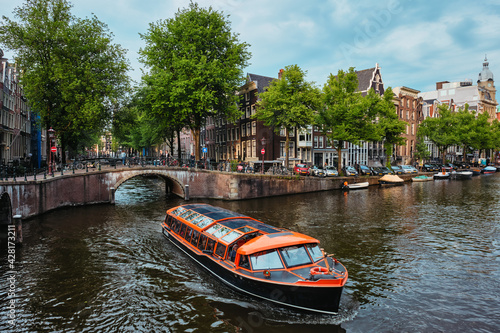 Photography Amsterdam view - canal with boad, bridge and old houses