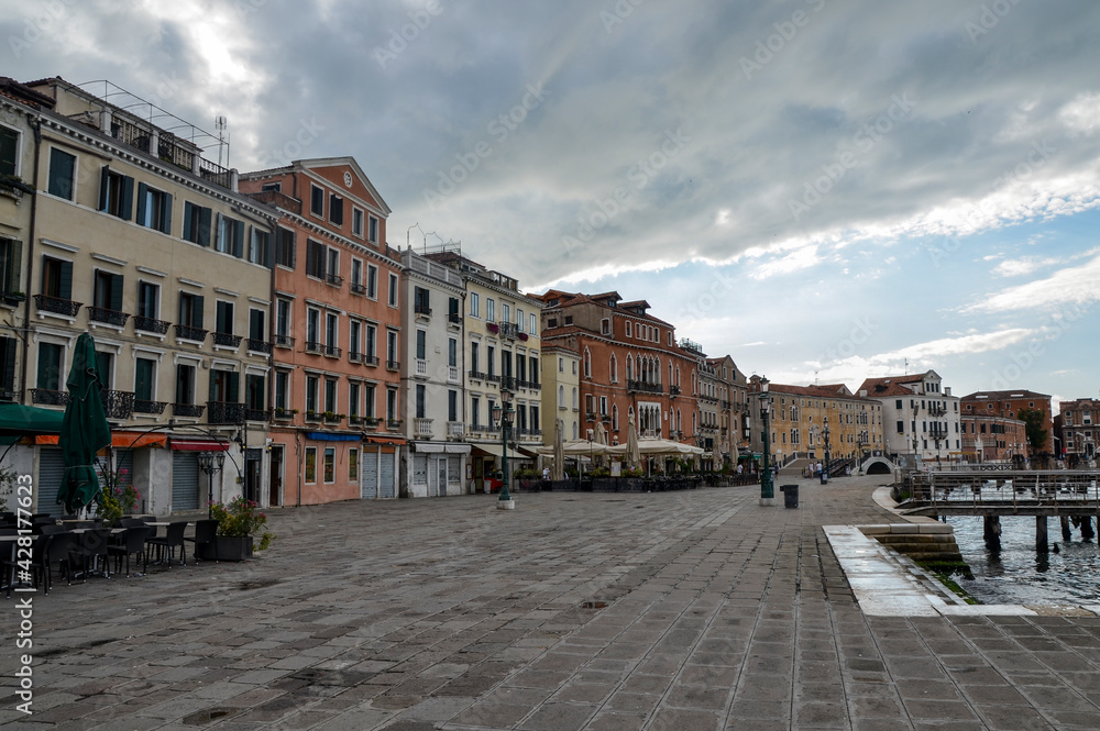 Facades of houses on Riva degli Schiavoni. Embankment without tourists near Doge`s Palace and San Marco square, Venice Italy.