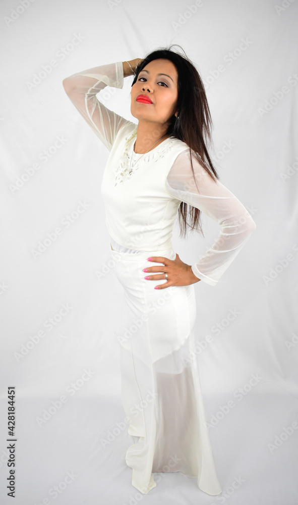 Beautiful latin girl wearing white dress in a white studio background Beautiful latin girl wearing white dress in a white studio background