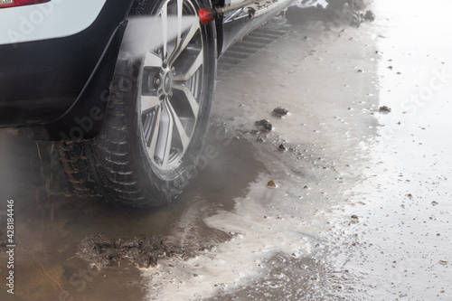 Close-up of a car under the water jet during the washing process on a self service car wash
