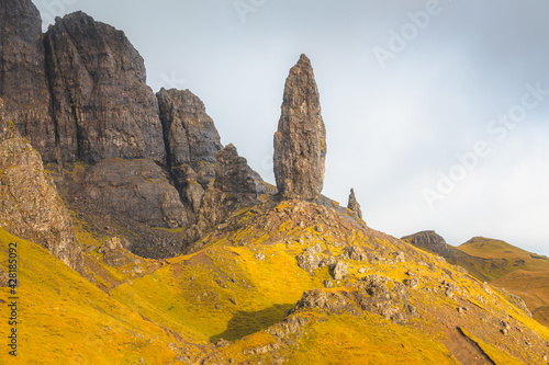 Dramatic golden light and shadow on the iconic rock pinnacle landscape Old Man of Storr on the Isle of Skye, Scotland.