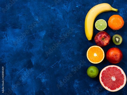 Ingredients for the healthy foods selection.Mix of different fruits grapefruit, kiwi, tangerine, apple, lime, sicilian orange, orange and banana