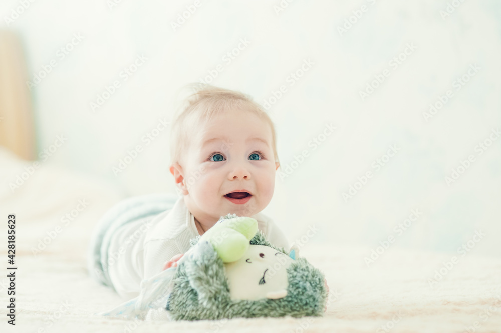 handsome cheerful boy crawling on the bed. handsome cheerful boy crawling on the bed.