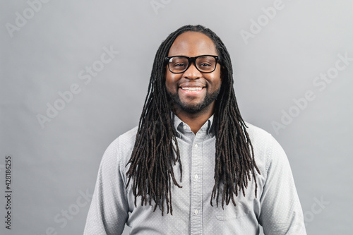 Canvas Print Smiling young handsome African American guy with dreadlocks in smart casual shir