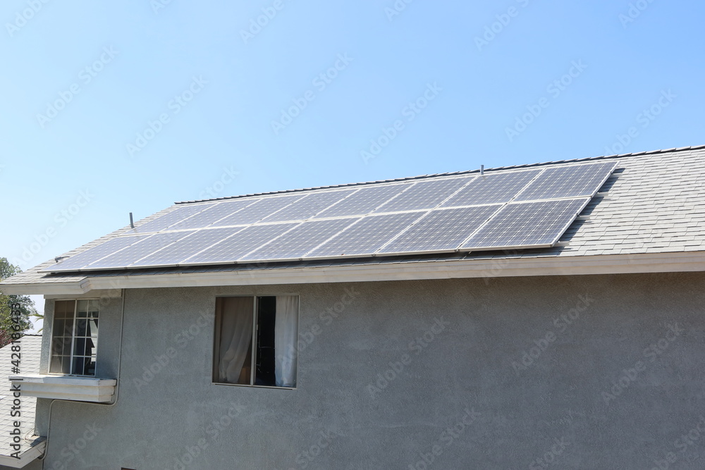 Solar Panels on a Residential House making Photovoltaic Electricity From the Sun Solar Panels on a Residential House making Photovoltaic Electricity From the Sun