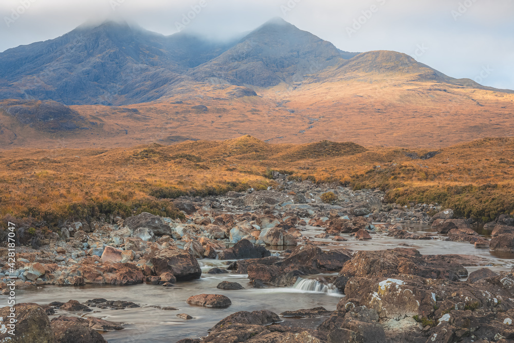Moody, scenic landscape view of the Black Cuillin mountains and stream at Sligachan  on the Isle of Skye, Scottish Highlands, Scotland.