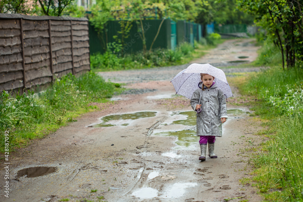 summer walk in the rain little girl with an umbrella summer walk in the rain little girl with an umbrella