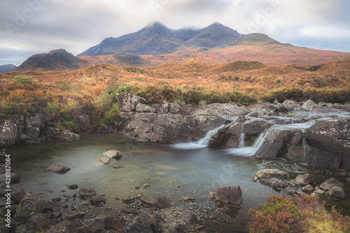 Scenic landscape view of the Black Cuillin mountains and Sligachan waterfall on the Isle of Skye, Scottish Highlands, Scotland.