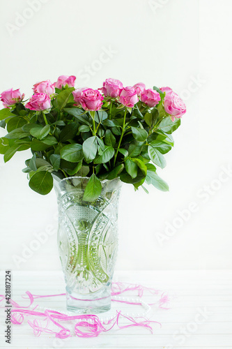 a bouquet of roses in a crystal vase photo