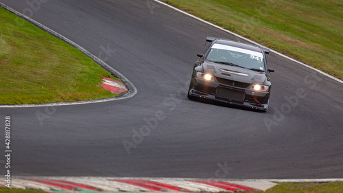 A shot of a racing car as it circuits a track. © SnapstitchPhoto