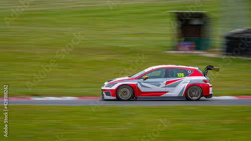 A panning shot of a racing car as it circuits a track. © SnapstitchPhoto