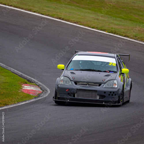 A shot of a racing car as it circuits a track.