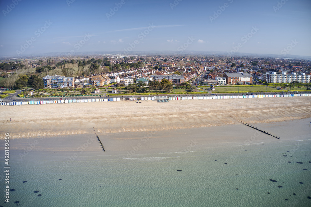 A row of brightly coloured beach huts in Bognor Regis with Marine Park Gardens in the background. Aerial Photo. A row of brightly coloured beach huts in Bognor Regis with Marine Park Gardens in the background. Aerial Photo.