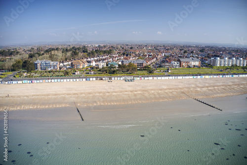 A row of brightly coloured beach huts in Bognor Regis with Marine Park Gardens in the background. Aerial Photo. © Geoff