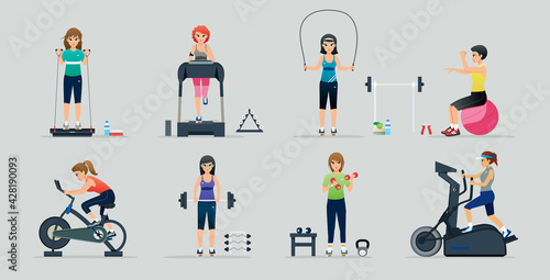 A woman using an exercise machine with a gray background.