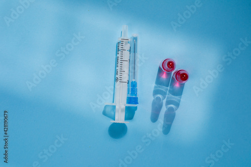 Liquid vitamin B12 for injections and syringe. Injection kit pink liquid and syringe.