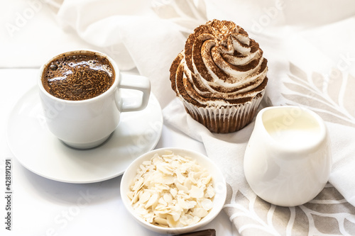 Dark chocolate and cocoa chocolate cupcakes with a cup of hot black coffee