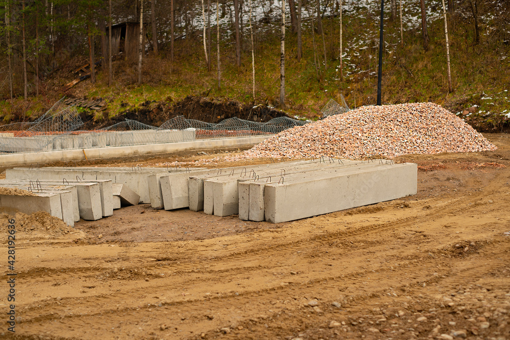Concrete curbs and red gravel on the site.