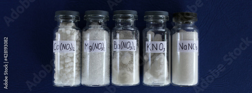 Nitrate salts of such metals: calcium, magnesium, barium, potassium, sodium, on a blue background.	
