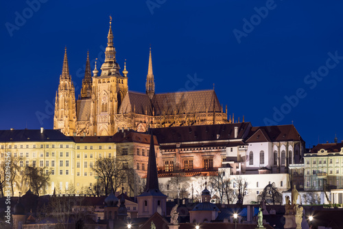 Scenic view on Prague Castle and the St. Vitus cathedral and historical center of Prague, buildings and landmarks of old town at sunrise or dusk, Prague, Czech Republic. Beautiful and romantic evening