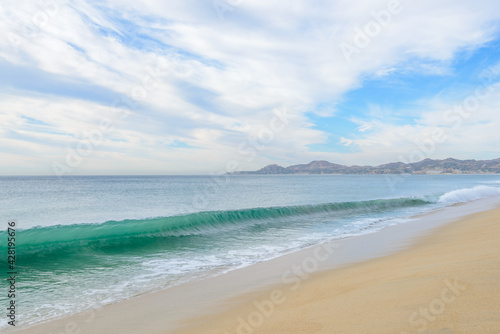Set of pictures of a fantastic ocean wave in different stages. Cloudy sunrise sky. San Jose del Cabo. Mexico. © karamysh