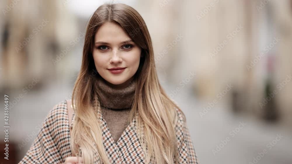 Closeup face of beautiful blond sexy smiling woman with long hair. Portrait of gorgeous girl looking to camera