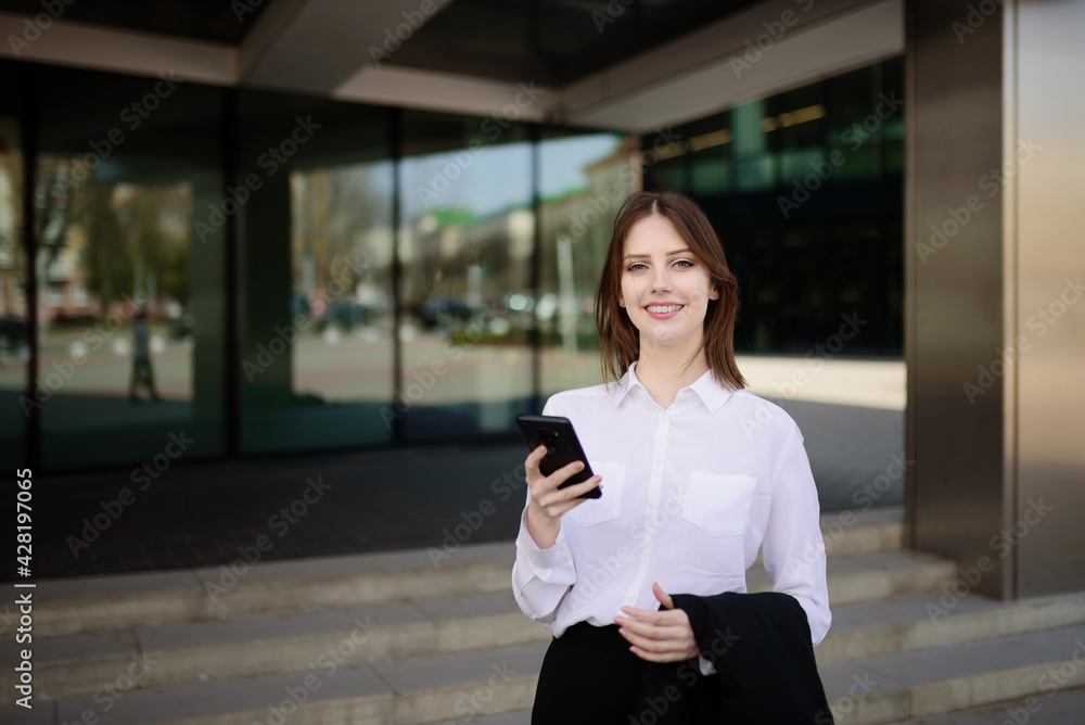 Young beautiful smiling girl replies to a message on her mobile phone Young beautiful smiling girl replies to a message on her mobile phone