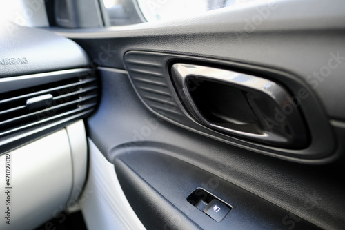 Interior door handle detail of a modern car © milotus