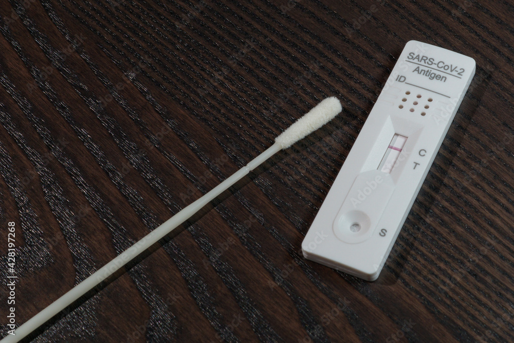 Negative rapid antigen SARSCoV2 test with test swab on a kitchen