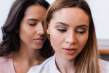 lesbian woman near brunette girlfriend on blurred background